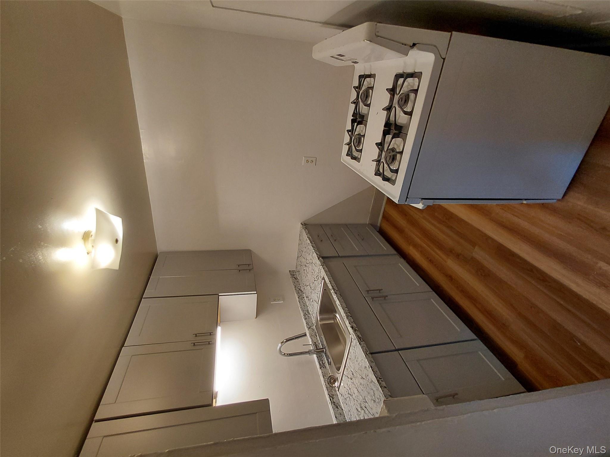 87 West Pierpont Street, Unit 4 Kingston, NY 12401 - Photo 1 of 13 a kitchen with granite countertop a sink a stove and cabinets