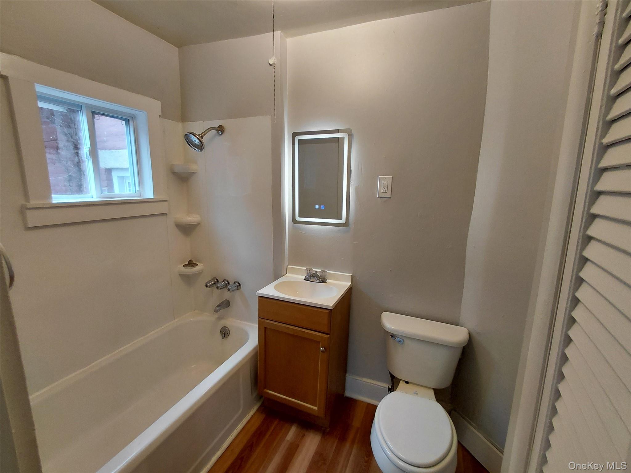 87 West Pierpont Street, Unit 4 Kingston, NY 12401 - Photo 12 of 13 a white toilet sitting next to a bath tub