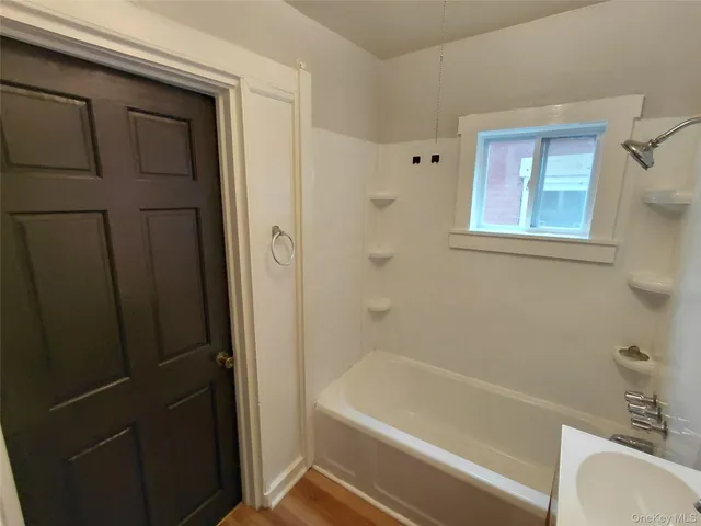 a bathroom with a bathtub and a sink