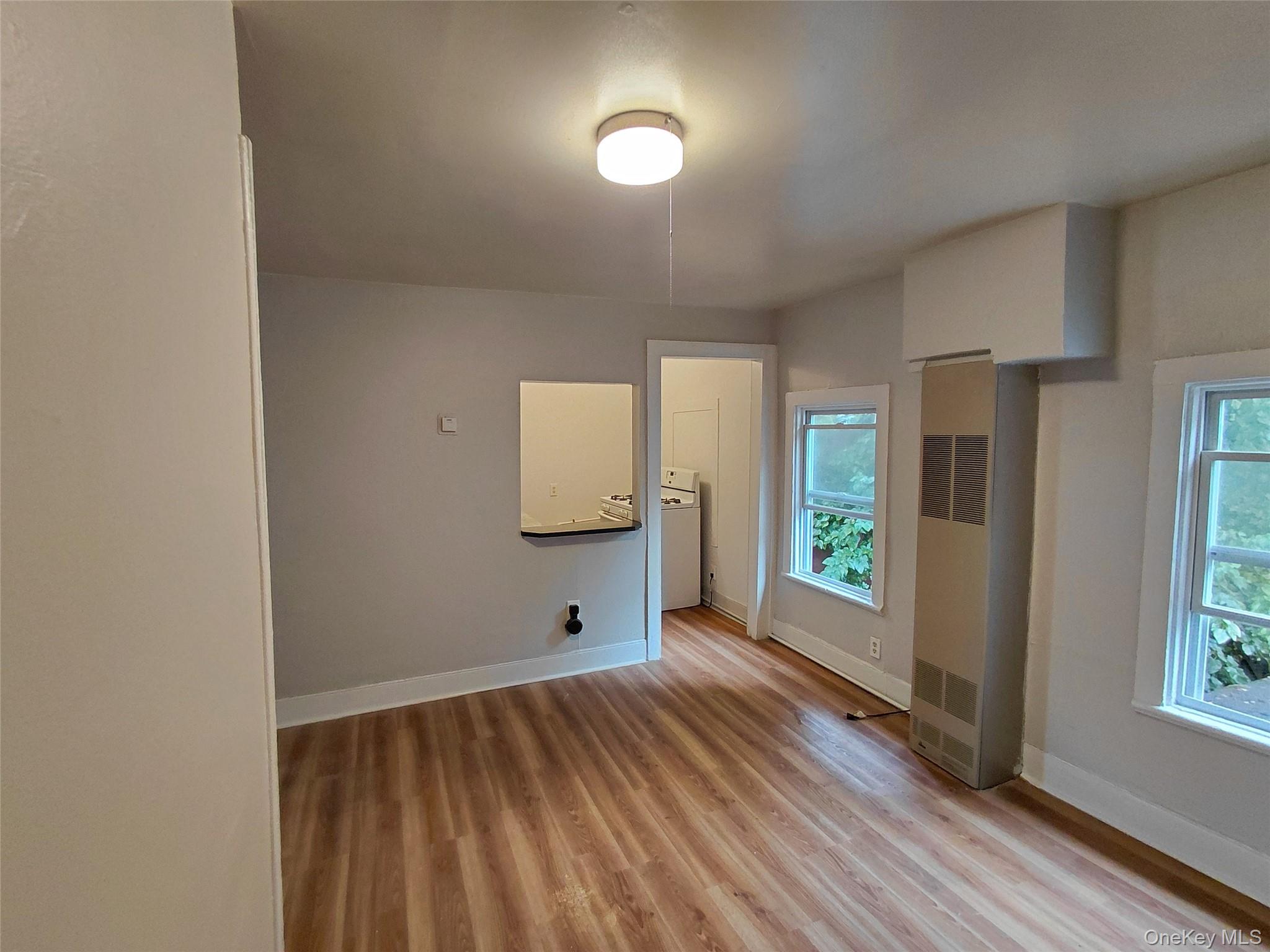 87 West Pierpont Street, Unit 4 Kingston, NY 12401 - Photo 3 of 13 a view of an empty room and window and wooden floor