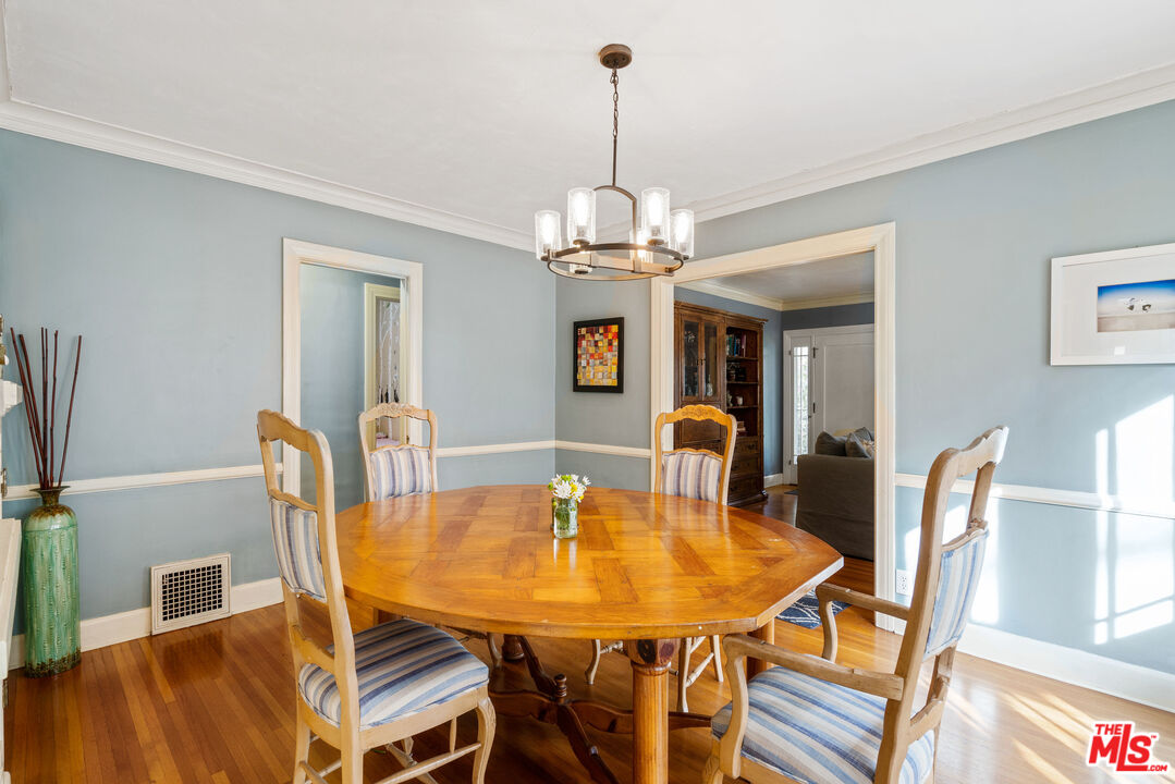 765 Mar Vista Avenue Pasadena, CA 91104 - Photo 13 of 42 a dining room with furniture a chandelier and window