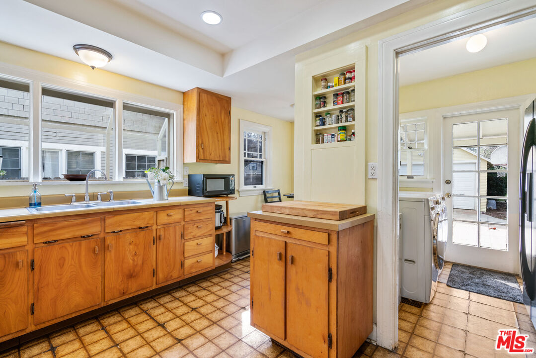 765 Mar Vista Avenue Pasadena, CA 91104 - Photo 14 of 42 a kitchen with stainless steel appliances granite countertop a refrigerator and a stove