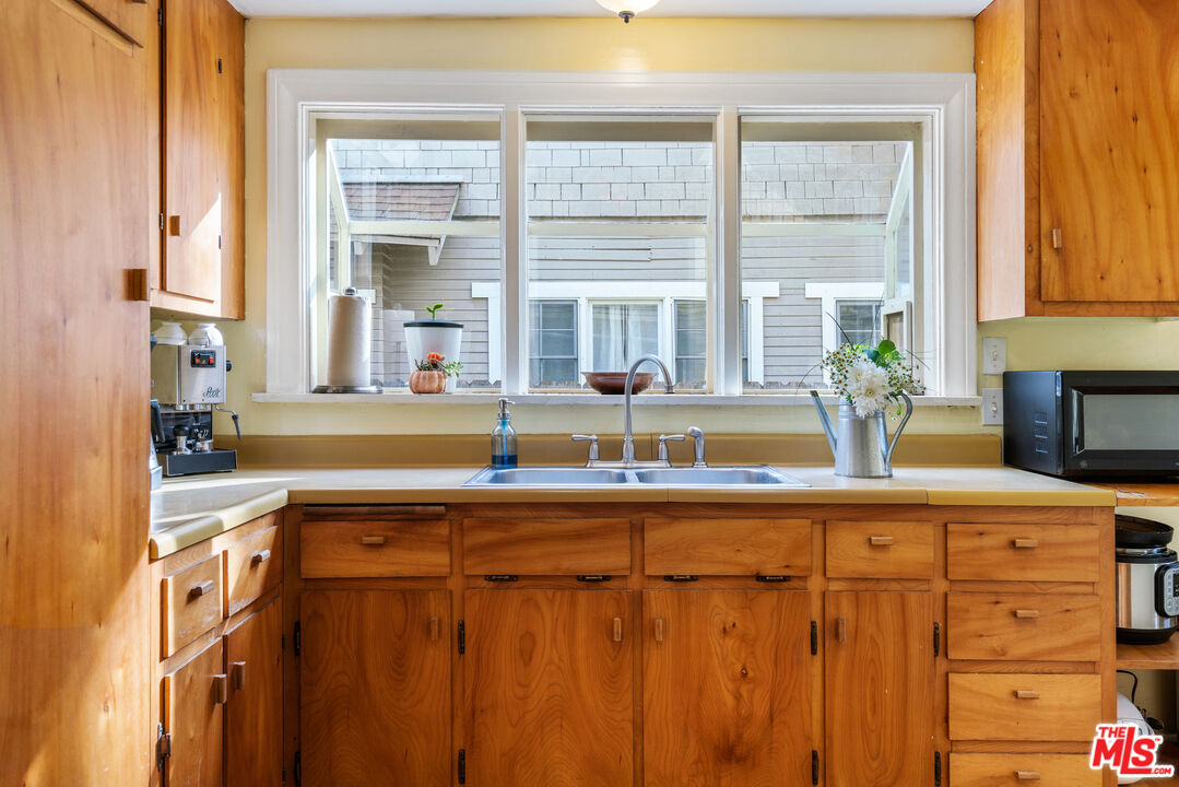 765 Mar Vista Avenue Pasadena, CA 91104 - Photo 15 of 42 a kitchen with stainless steel appliances a sink and a window