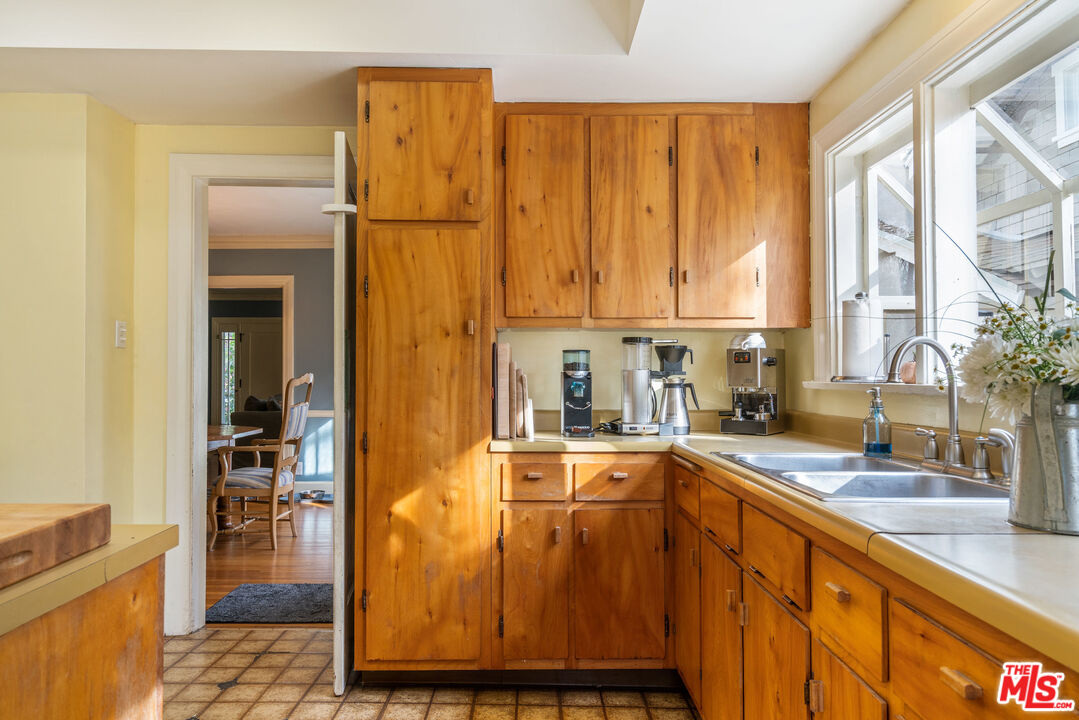 765 Mar Vista Avenue Pasadena, CA 91104 - Photo 20 of 42 a kitchen with wooden cabinets and sink