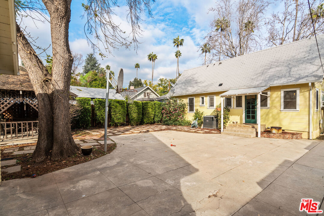 765 Mar Vista Avenue Pasadena, CA 91104 - Photo 27 of 42 a view of a patio with a table and chairs under an umbrella