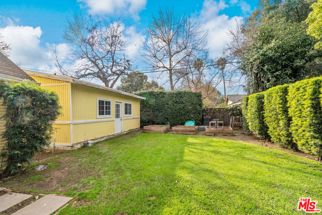 765 Mar Vista Avenue Pasadena, CA 91104 - Photo 34 of 42 a view of a house with a large tree and a yard