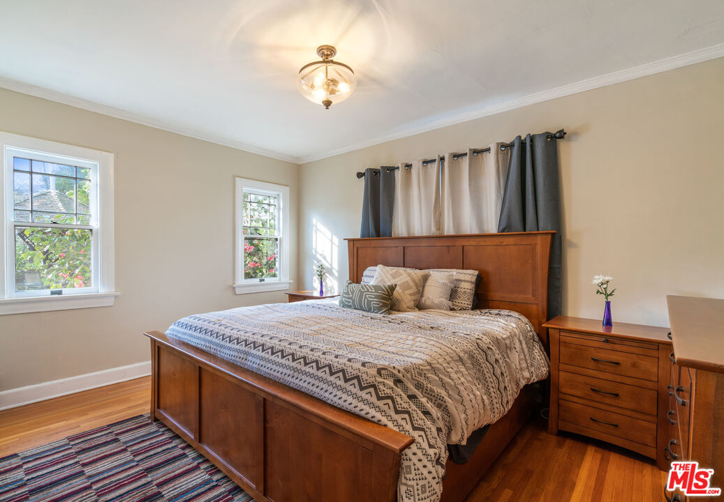 765 Mar Vista Avenue Pasadena, CA 91104 - Photo 39 of 42 a bedroom with a bed and wooden floor