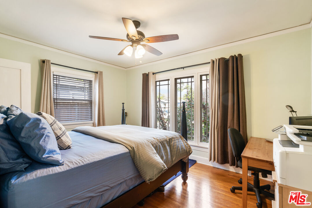 765 Mar Vista Avenue Pasadena, CA 91104 - Photo 41 of 42 a bedroom with a bed wooden floor and a large window