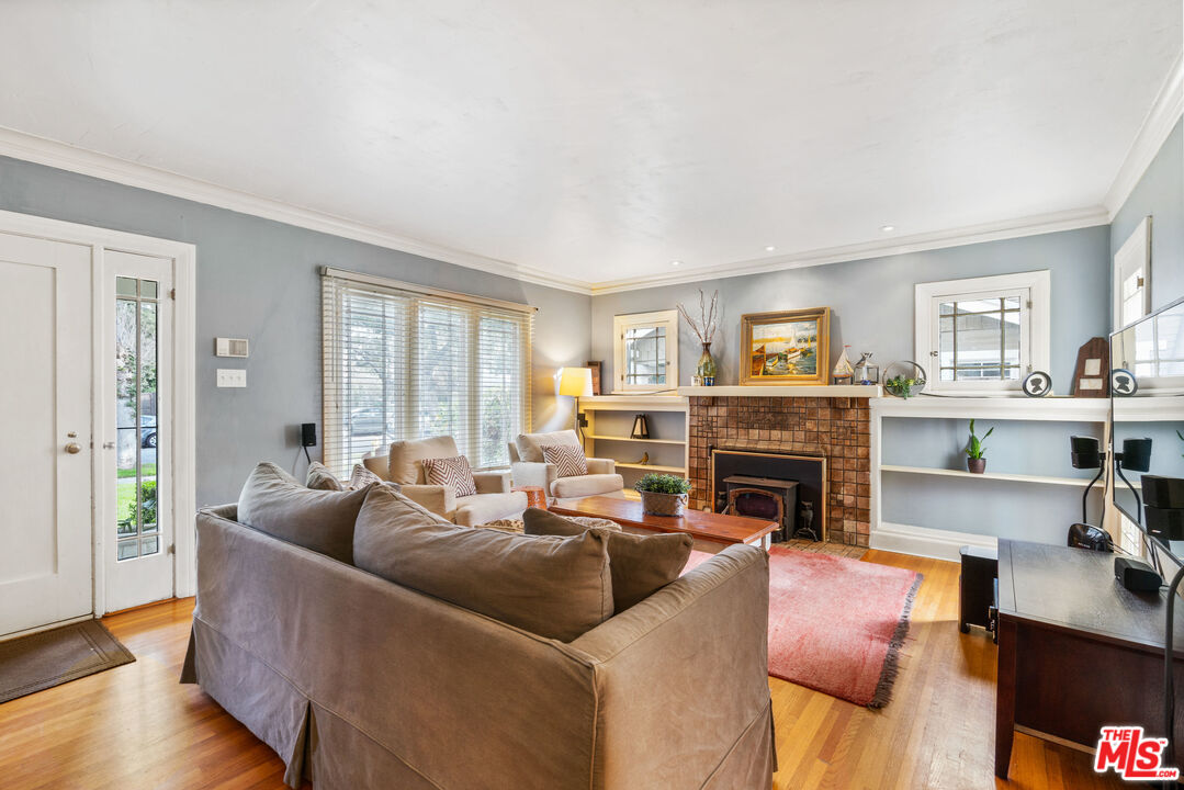 765 Mar Vista Avenue Pasadena, CA 91104 - Photo 7 of 42 a living room with furniture and a fireplace