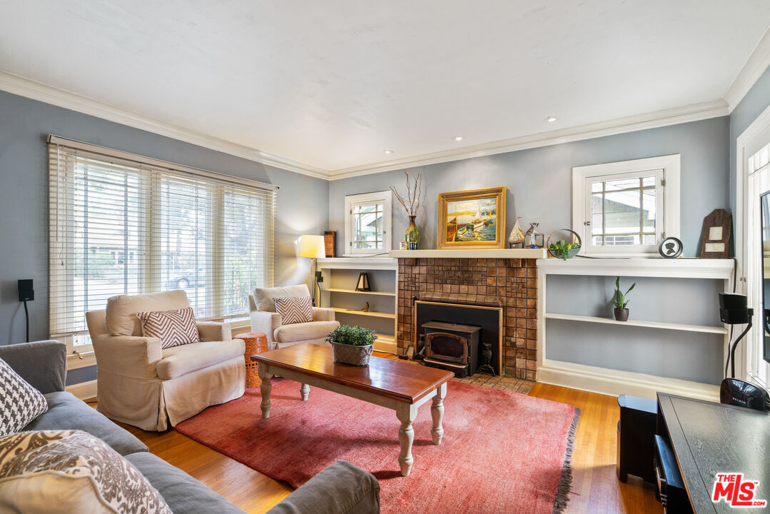 765 Mar Vista Avenue Pasadena, CA 91104 - Photo 8 of 42 a living room with furniture and a fireplace