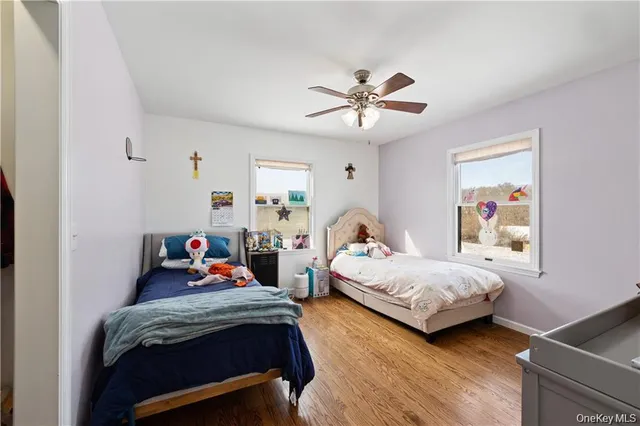 a bedroom with two beds and a chandelier