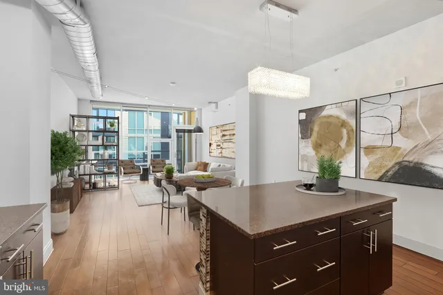 a kitchen with a table chairs and wooden floor