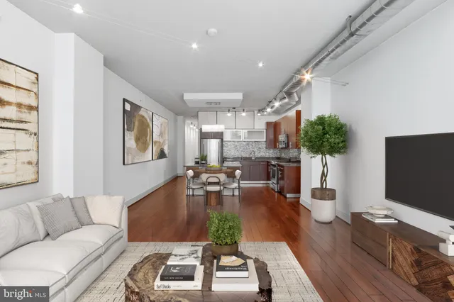 a living room with furniture a flat screen tv and a large window