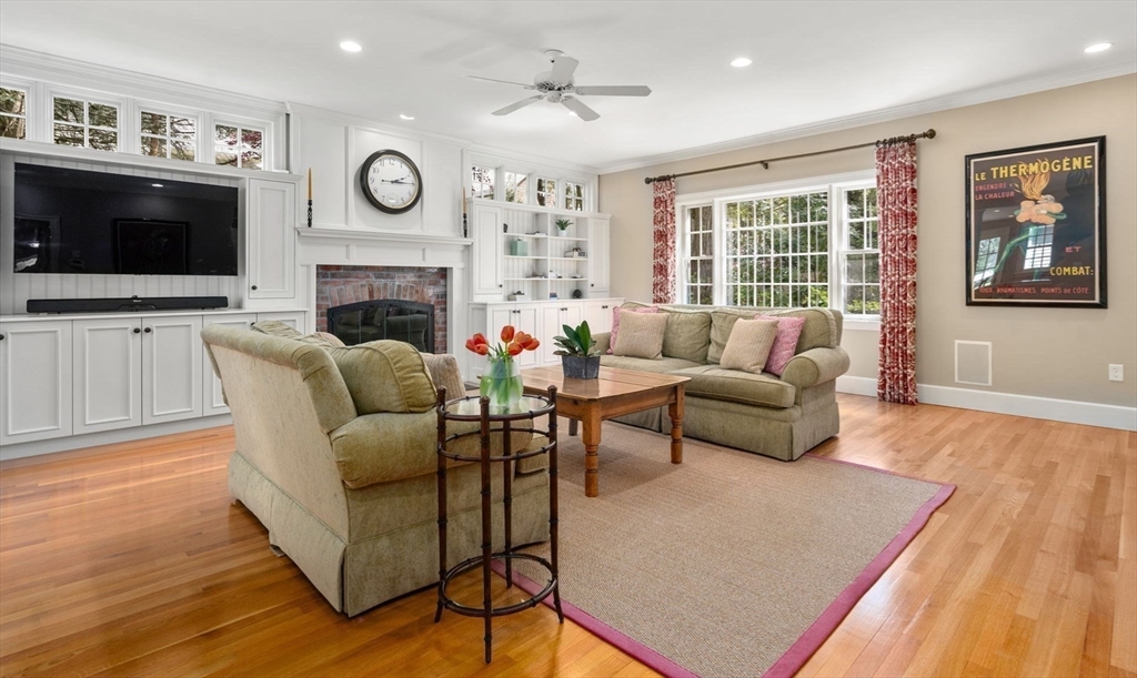 30 Park Avenue Wellesley, MA 02481 - Photo 12 of 36 a living room with furniture a flat screen tv and a fireplace