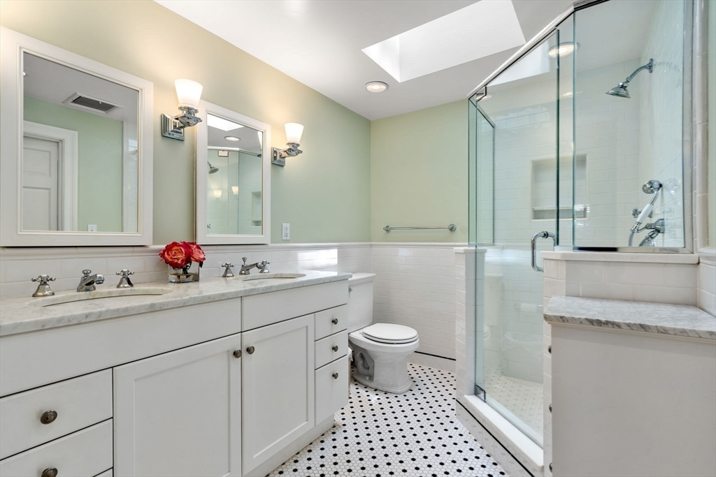 30 Park Avenue Wellesley, MA 02481 - Photo 20 of 36 a bathroom with a sink a toilet and a mirror