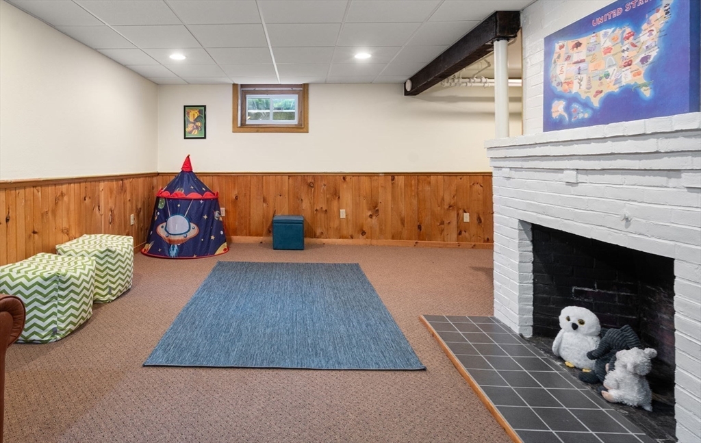 30 Park Avenue Wellesley, MA 02481 - Photo 28 of 36 a living room with large couch and a fireplace