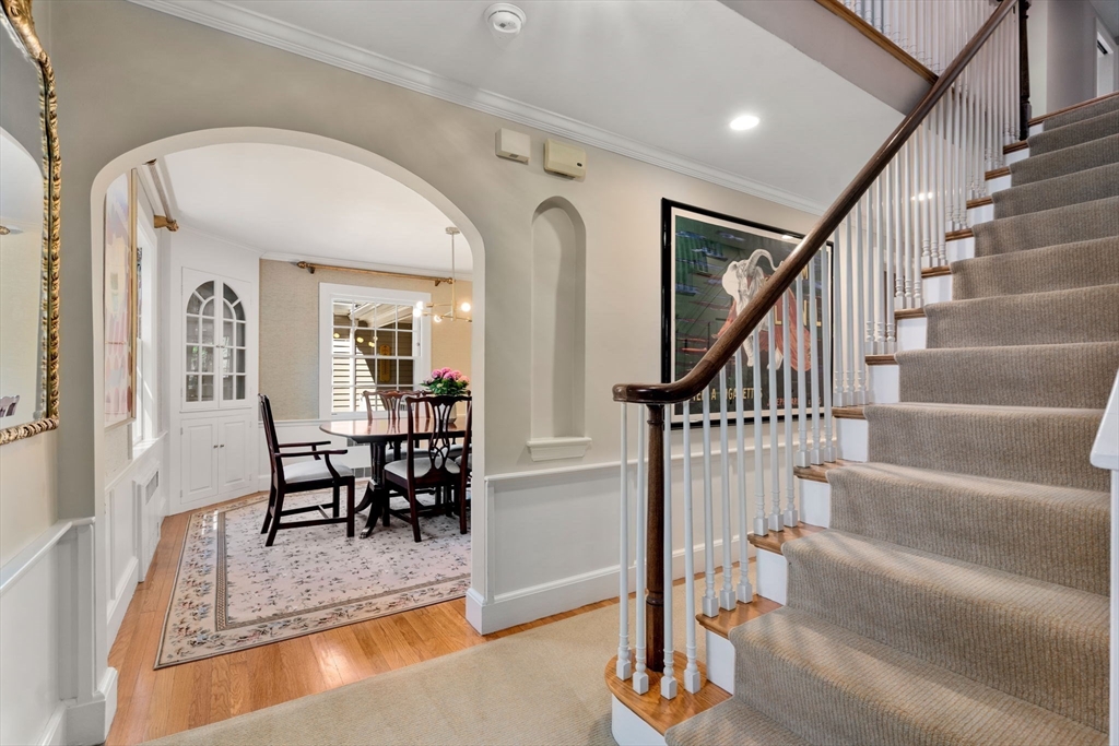 30 Park Avenue Wellesley, MA 02481 - Photo 4 of 36 a view of staircase with furniture and a dining table with wooden floor