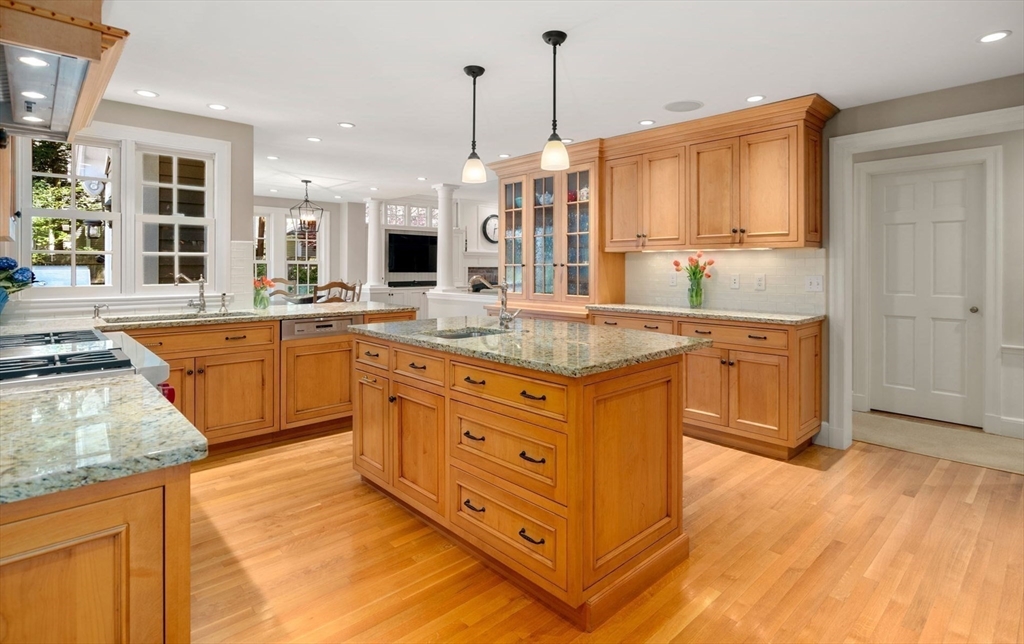 30 Park Avenue Wellesley, MA 02481 - Photo 7 of 36 a kitchen with stainless steel appliances granite countertop a sink a stove and a refrigerator