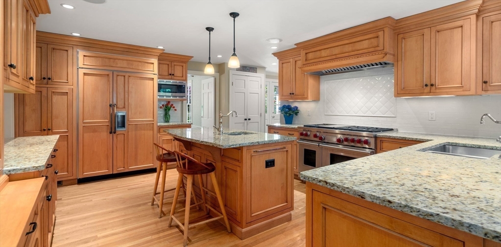30 Park Avenue Wellesley, MA 02481 - Photo 8 of 36 a kitchen with stainless steel appliances granite countertop wooden cabinets a sink and a stove
