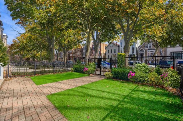 2510 North Burling Street, Unit 1 Chicago, IL 60614 - Photo 2 of 9 a view of a backyard with potted plants and large trees