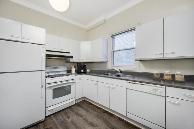 2510 North Burling Street, Unit 1 Chicago, IL 60614 - Photo 6 of 9 a kitchen with granite countertop white cabinets and white appliances