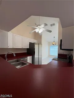 a kitchen with a sink a stove and cabinets