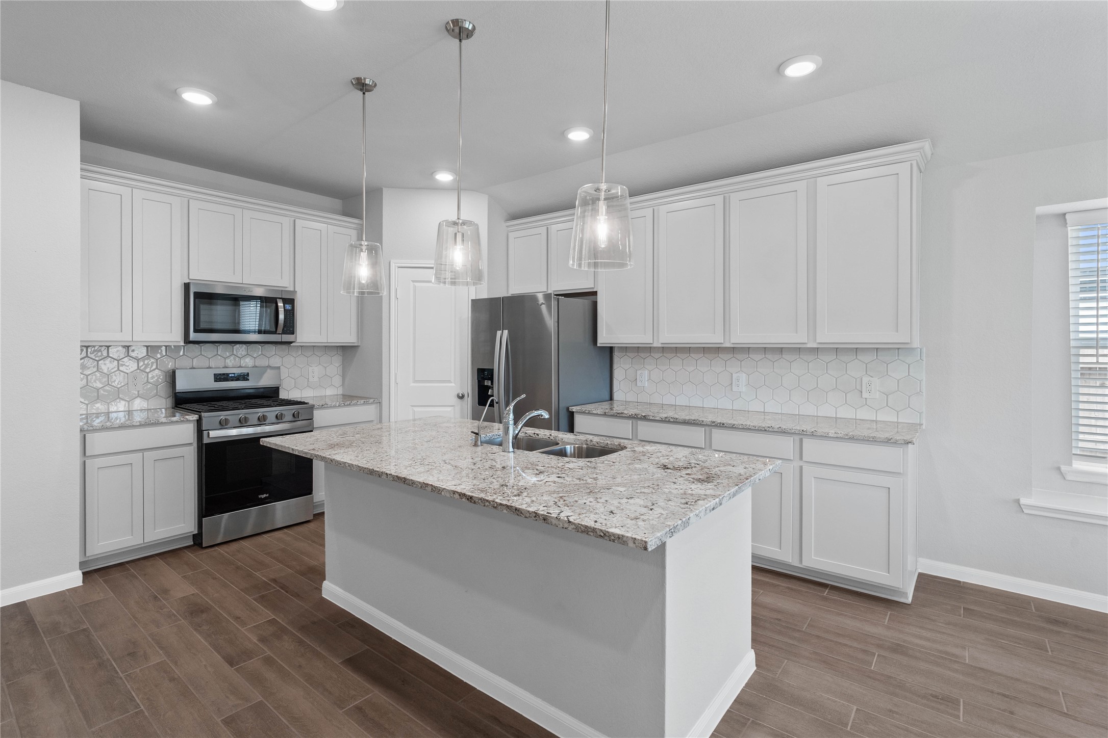 19645 Montgomery Rdg Way Montgomery, TX 77316 - Photo 20 of 41 This gorgeous kitchen is an entertainer’s dream, featuring an oversized island, premium finishes, and abundant storage. Designed as the home's ultimate social hub, it offers the perfect balance of open-concept beauty and functional workspace.