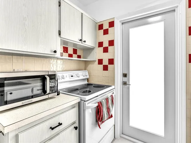 a kitchen with cabinets and appliances