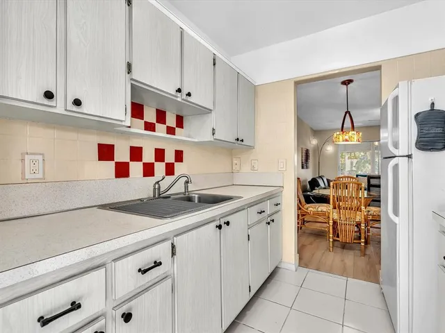 a kitchen with cabinets and window