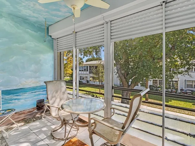 a view of a room with furniture and large windows