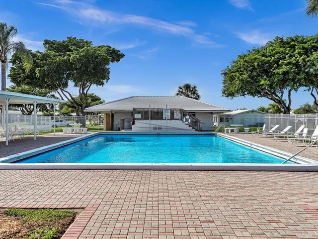 a room with pool table and wooden floor