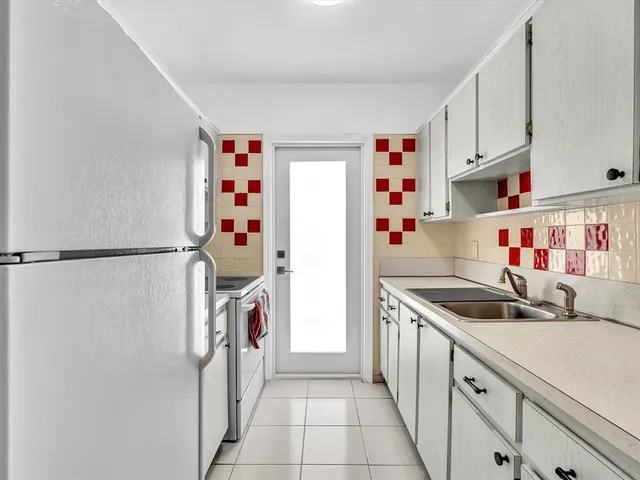 a utility room with cabinets washer and dryer