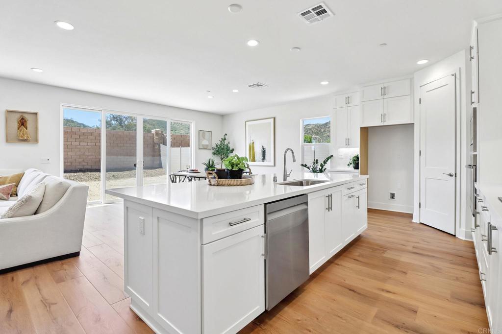 3521 Butler Place Escondido, CA 92027 - Photo 19 of 50 a large white kitchen with a large window