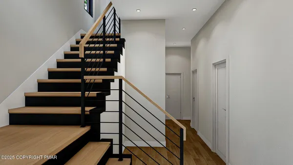 a view of entryway and hall with wooden floor