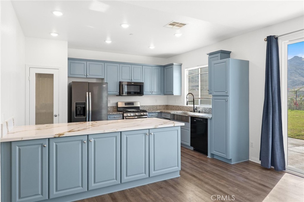 20765 Barn Road Riverside, CA 92507 - Photo 14 of 56 a kitchen with kitchen island granite countertop a refrigerator stove top oven and sink