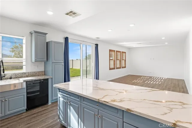 a kitchen with stainless steel appliances granite countertop a stove a refrigerator and a sink