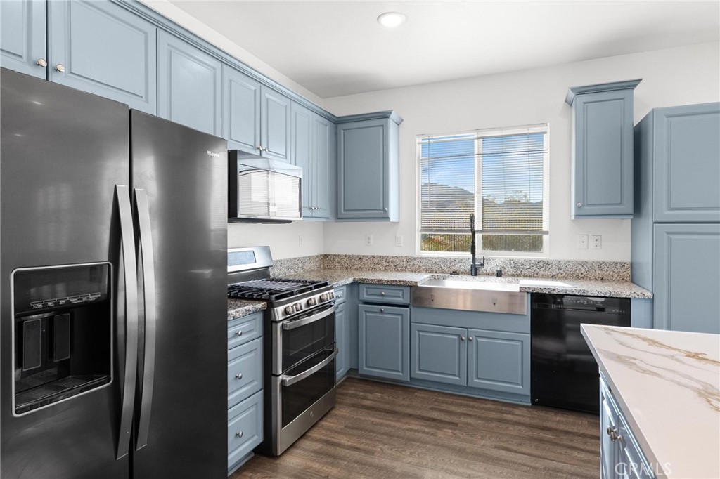 20765 Barn Road Riverside, CA 92507 - Photo 16 of 56 a kitchen with stainless steel appliances granite countertop a stove a refrigerator and a sink