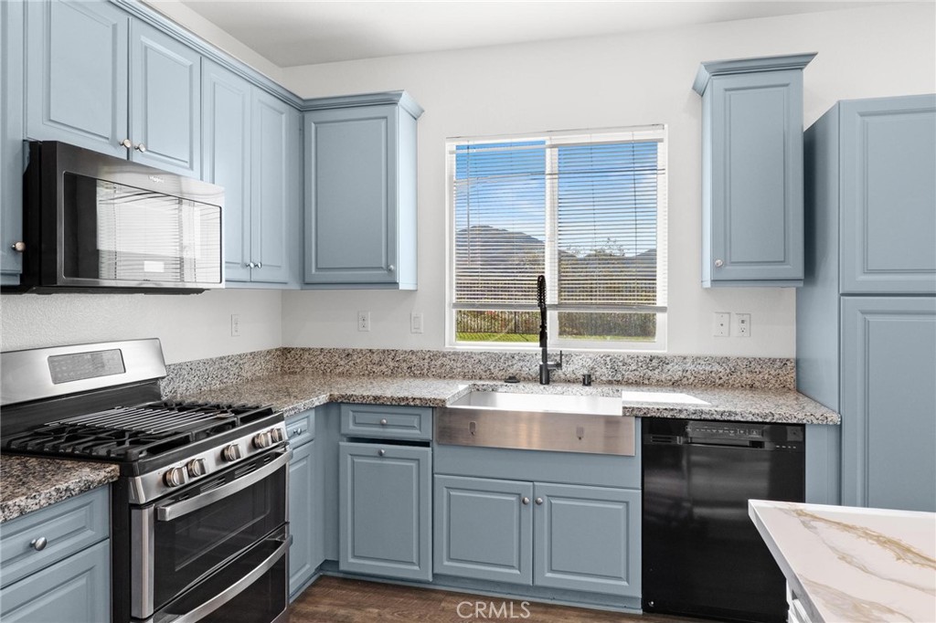20765 Barn Road Riverside, CA 92507 - Photo 17 of 56 a kitchen with granite countertop a sink stainless steel appliances and cabinets