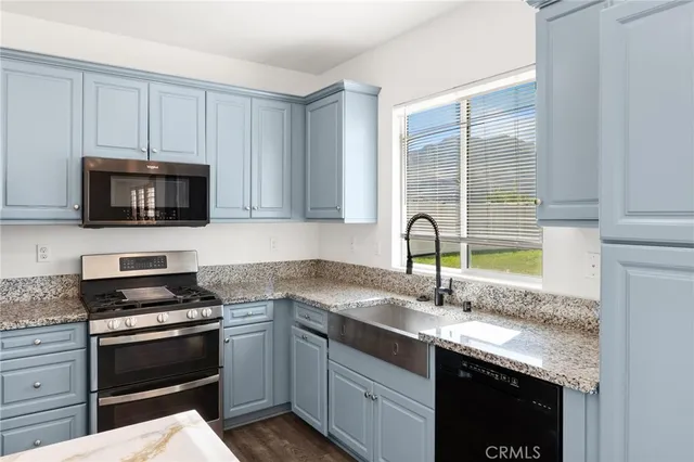 a view of a kitchen with wooden floor and a kitchen