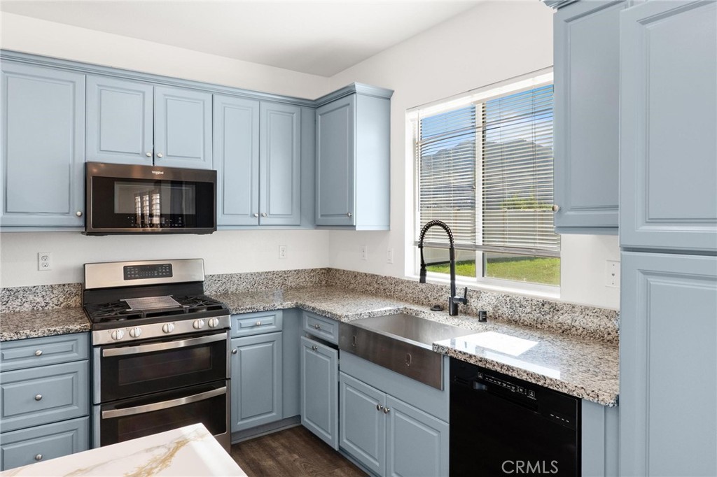 20765 Barn Road Riverside, CA 92507 - Photo 18 of 56 a kitchen with granite countertop a sink stainless steel appliances and cabinets