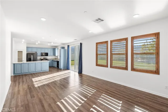 a spacious bedroom with a bed and a window