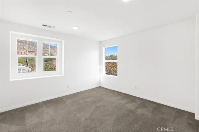 a bed room with furniture and a potted plant