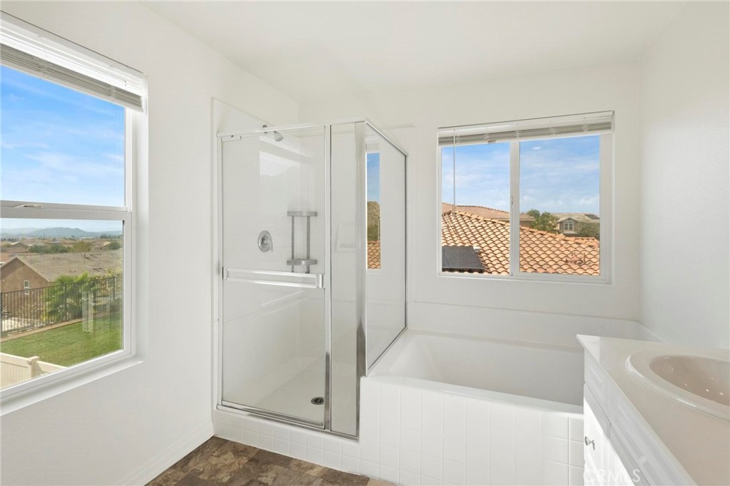 20765 Barn Road Riverside, CA 92507 - Photo 33 of 56 a bathroom with a bathtub and a shower