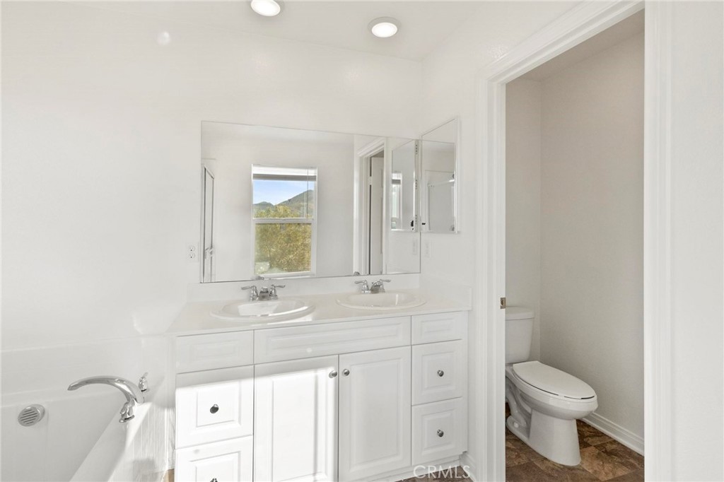 20765 Barn Road Riverside, CA 92507 - Photo 34 of 56 a bathroom with a sink a toilet and shower