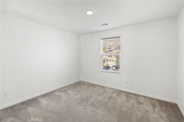 a bathroom with a granite countertop sink a toilet and a large mirror