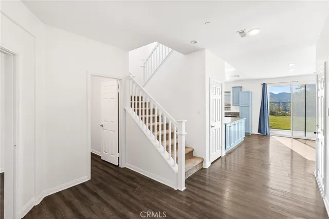 a view of an entryway with wooden floor