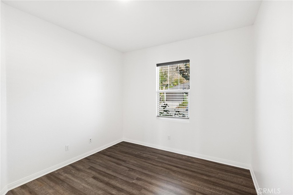 20765 Barn Road Riverside, CA 92507 - Photo 8 of 56 a view of an empty room with wooden floor and a window