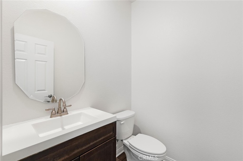 20765 Barn Road Riverside, CA 92507 - Photo 10 of 56 a bathroom with a sink a toilet and mirror