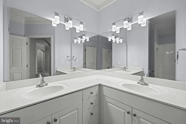 a bathroom with a sink vanity and a mirror