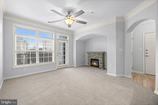 a view of a livingroom with a fireplace and fan